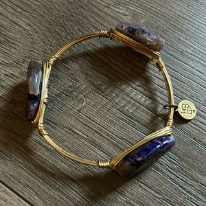 Gold wire bracelet with three purple geodes
